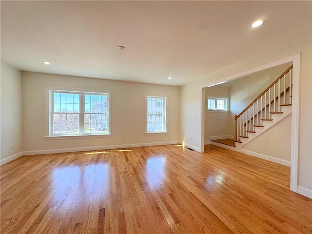 1404 Hunting Hill Dr, Cumberland, RI 02864 - unfurnished living room with light wood-style flooring, baseboards, recessed lighting, and stairs