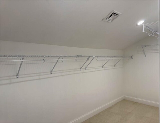 1404 Hunting Hill Dr, Cumberland, RI 02864 - walk in closet with vaulted ceiling, visible vents, and light carpet