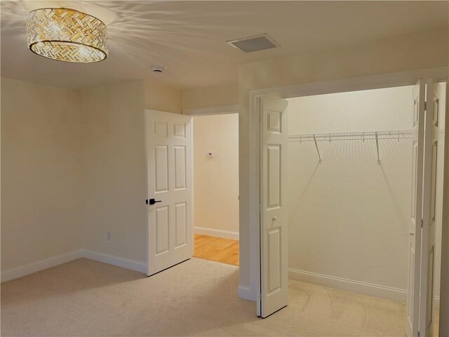 1404 Hunting Hill Dr, Cumberland, RI 02864 - unfurnished bedroom featuring baseboards, visible vents, a closet, and light colored carpet