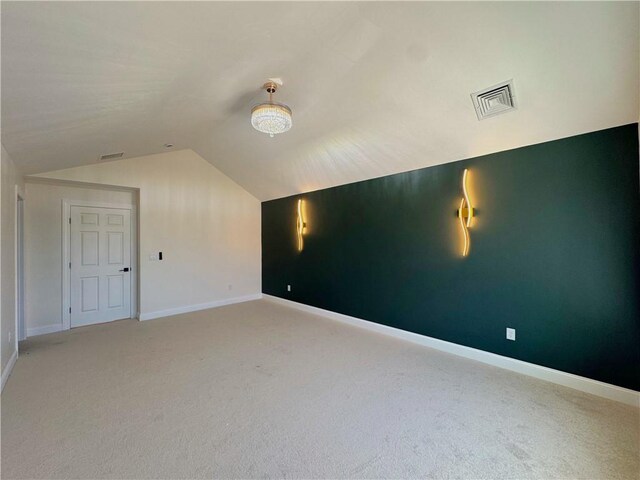 1404 Hunting Hill Dr, Cumberland, RI 02864 - additional living space with vaulted ceiling, visible vents, baseboards, and light carpet