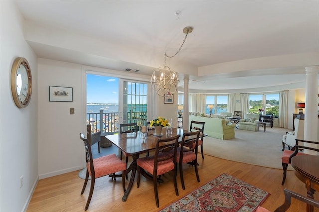 53 Conanicus Ave Unit 5A, Jamestown, RI 02835 - dining room with an inviting chandelier, plenty of natural light, light wood-style flooring, and visible vents