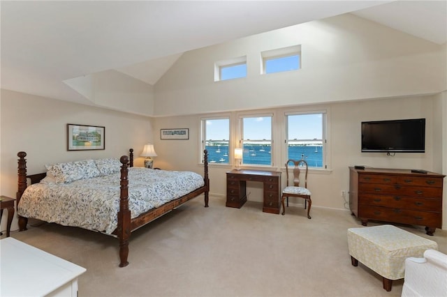 53 Conanicus Ave Unit 5A, Jamestown, RI 02835 - bedroom with light carpet, high vaulted ceiling, and baseboards