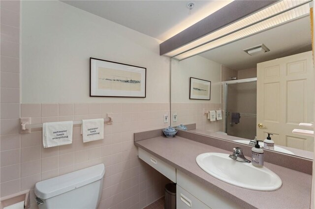 53 Conanicus Ave Unit 5A, Jamestown, RI 02835 - full bathroom with vanity, an enclosed shower, toilet, visible vents, and tile walls