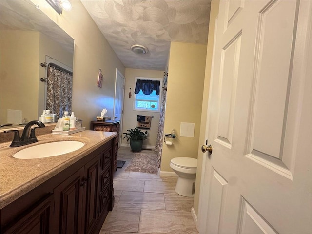 full bath featuring toilet, curtained shower, marble finish floor, and vanity