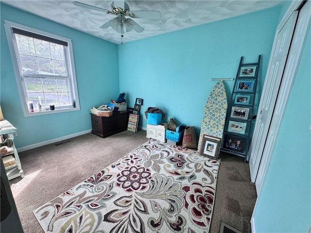 bedroom featuring visible vents, a ceiling fan, carpet flooring, and baseboards