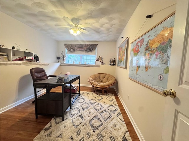 office space featuring a ceiling fan, wood finished floors, and baseboards