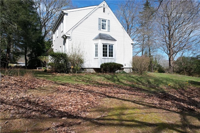 23 Rockland Dr, South Kingstown, RI 02879 - view of side of home with a lawn