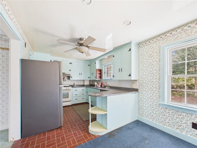 23 Rockland Dr, South Kingstown, RI 02879 - kitchen featuring freestanding refrigerator, gas range gas stove, and wallpapered walls