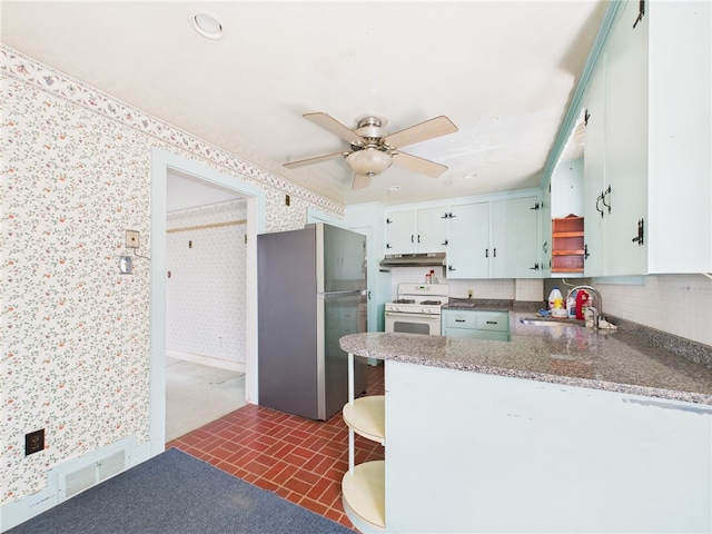 23 Rockland Dr, South Kingstown, RI 02879 - kitchen with a sink, freestanding refrigerator, under cabinet range hood, white range with gas stovetop, and wallpapered walls