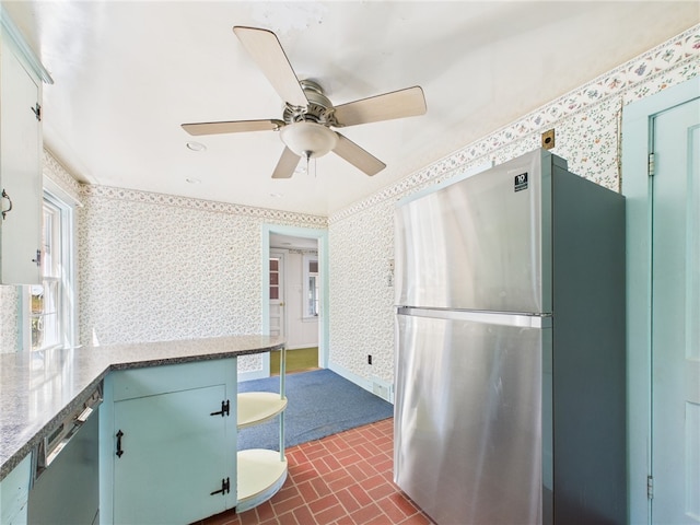 23 Rockland Dr, South Kingstown, RI 02879 - kitchen with wallpapered walls, freestanding refrigerator, dishwashing machine, and brick patterned floor