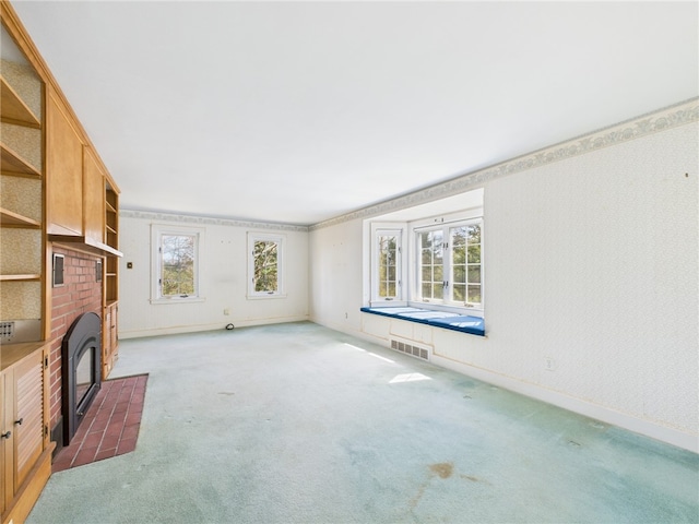 23 Rockland Dr, South Kingstown, RI 02879 - unfurnished living room with carpet flooring, visible vents, baseboards, and a brick fireplace