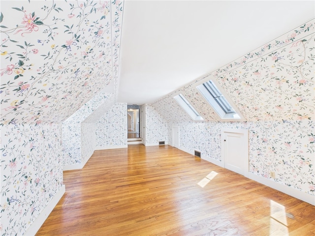 23 Rockland Dr, South Kingstown, RI 02879 - bonus room featuring light wood-type flooring, visible vents, a skylight, wallpapered walls, and baseboards