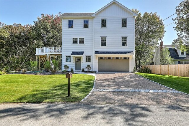 137 Rosebriar Ave, South Kingstown, RI 02879 - view of front facade with a garage, stairway, fence, a front lawn, and gravel driveway