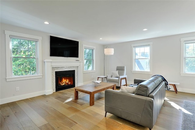137 Rosebriar Ave, South Kingstown, RI 02879 - living room with light wood finished floors, baseboards, a glass covered fireplace, and recessed lighting
