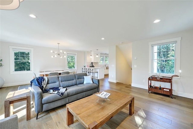 137 Rosebriar Ave, South Kingstown, RI 02879 - living room featuring light wood-type flooring, baseboards, recessed lighting, and a notable chandelier