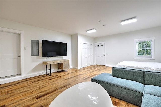 137 Rosebriar Ave, South Kingstown, RI 02879 - living room featuring baseboards, wood finished floors, and electric panel
