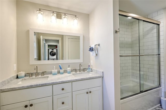 137 Rosebriar Ave, South Kingstown, RI 02879 - bathroom featuring stacked washer and dryer, double vanity, a sink, and combined bath / shower with glass door