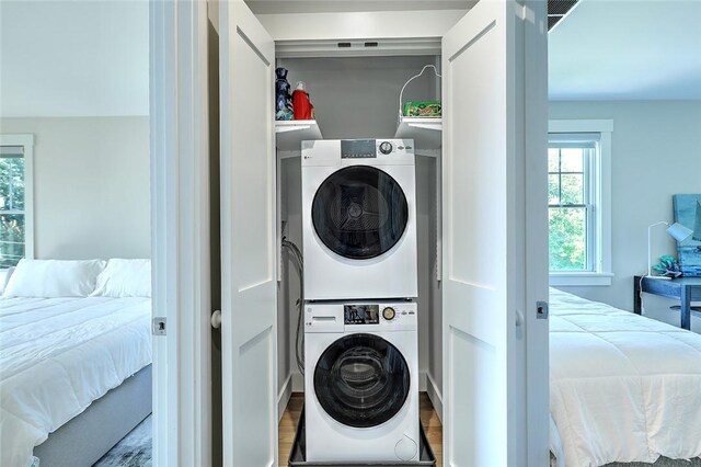 137 Rosebriar Ave, South Kingstown, RI 02879 - clothes washing area featuring laundry area, wood finished floors, and stacked washer / drying machine