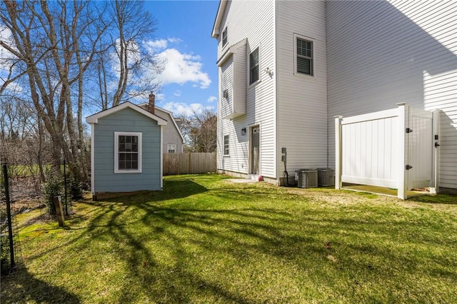 137 Rosebriar Ave, South Kingstown, RI 02879 - view of side of home with fence, an outdoor structure, and a yard