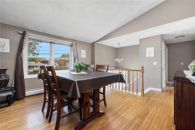 dining area featuring lofted ceiling, baseboard heating, baseboards, an inviting chandelier, and light wood-style floors