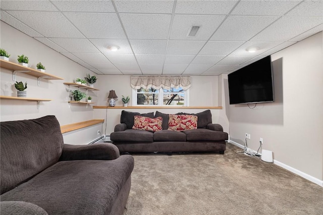 living area featuring a paneled ceiling, carpet floors, visible vents, baseboards, and a baseboard radiator