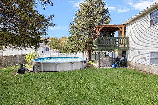view of swimming pool with a lawn, a fenced in pool, and a fenced backyard