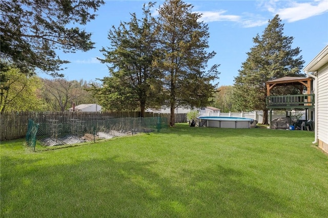 view of yard featuring a fenced backyard, a gazebo, and a fenced in pool