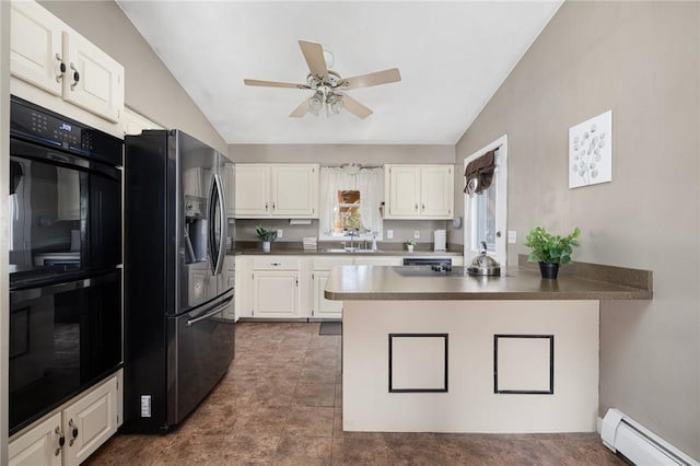 kitchen featuring a peninsula, stainless steel fridge, dobule oven black, vaulted ceiling, and a baseboard radiator