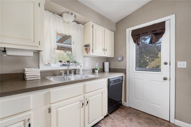 kitchen featuring dishwasher, baseboards, a sink, dark countertops, and white cabinets
