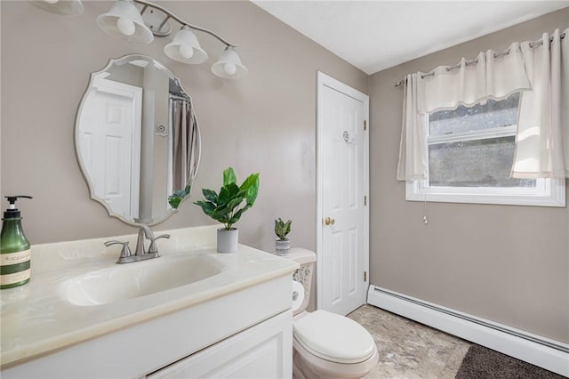 bathroom with toilet, a baseboard radiator, and vanity