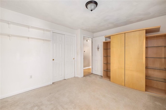 unfurnished bedroom featuring two closets, carpet, and baseboards