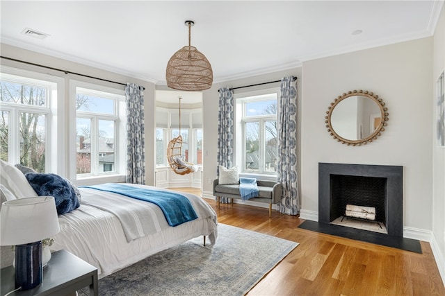 78 Rhode Island Ave Unit 5, Newport, RI 02840 - bedroom with a fireplace with flush hearth, wood finished floors, crown molding, and visible vents
