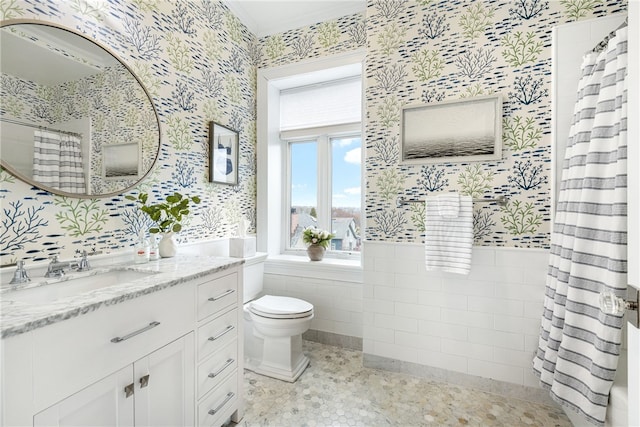 78 Rhode Island Ave Unit 5, Newport, RI 02840 - full bathroom with tile walls, vanity, toilet, a wainscoted wall, and wallpapered walls
