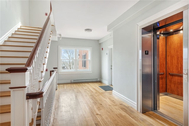 78 Rhode Island Ave Unit 5, Newport, RI 02840 - interior space featuring elevator, baseboard heating, baseboards, light wood finished floors, and stairs