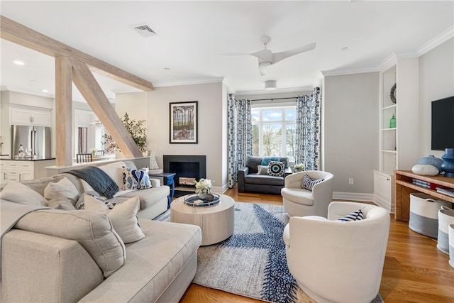 78 Rhode Island Ave Unit 5, Newport, RI 02840 - living room featuring a fireplace, visible vents, light wood-style flooring, baseboards, and ornamental molding