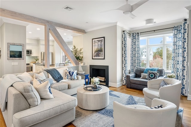 78 Rhode Island Ave Unit 5, Newport, RI 02840 - living area with visible vents, ceiling fan, light wood-style floors, baseboards, and ornamental molding
