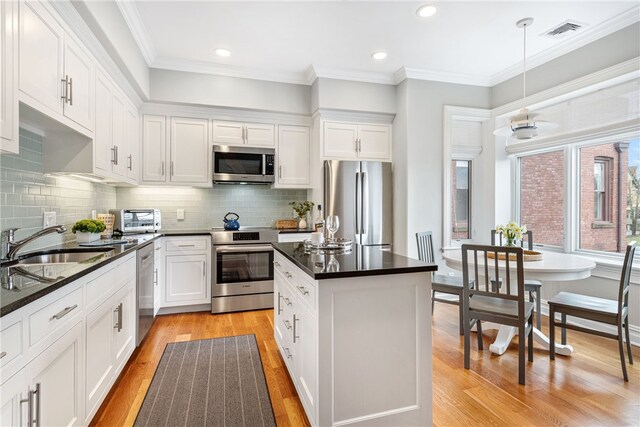 78 Rhode Island Ave Unit 5, Newport, RI 02840 - kitchen featuring visible vents, stainless steel appliances, dark countertops, and a sink