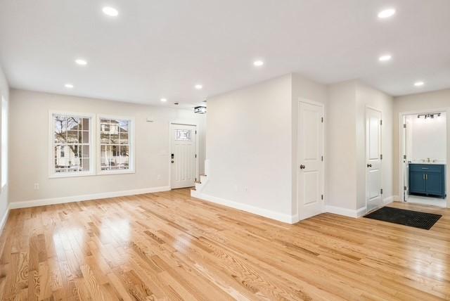 interior space featuring recessed lighting, light wood finished floors, and baseboards