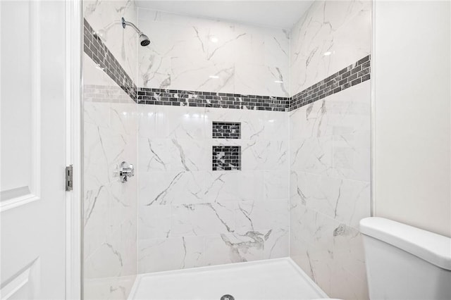 full bath with toilet and a stall shower