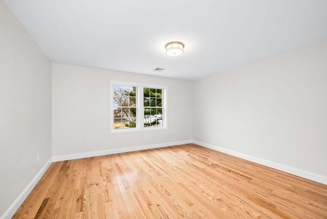 unfurnished room featuring light wood-style flooring and baseboards