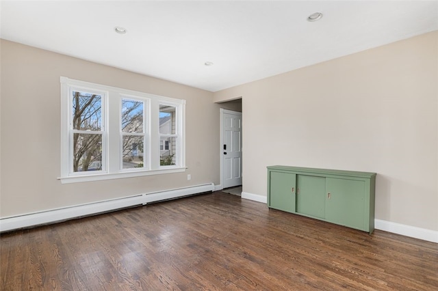 unfurnished room featuring recessed lighting, dark wood-style floors, a baseboard radiator, and baseboards