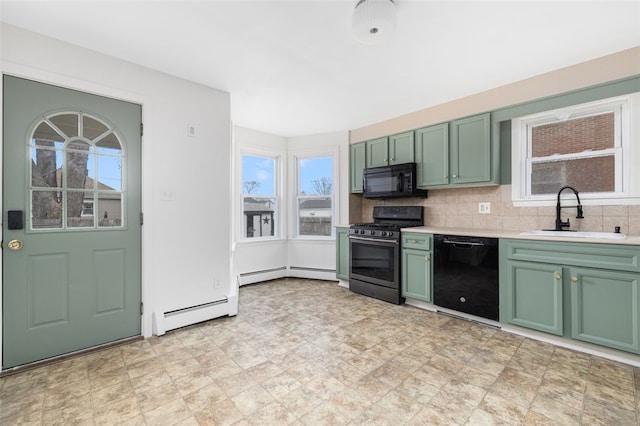 kitchen featuring green cabinetry, a sink, black appliances, and a healthy amount of sunlight