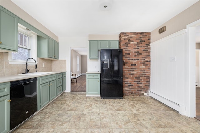 kitchen featuring a baseboard heating unit, light countertops, black appliances, green cabinetry, and a sink