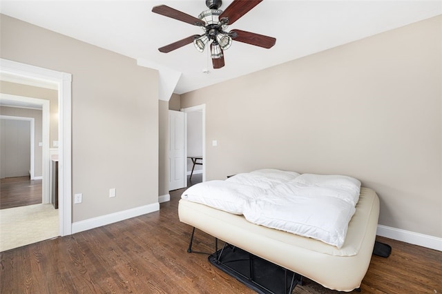 bedroom featuring ceiling fan, baseboards, and wood finished floors