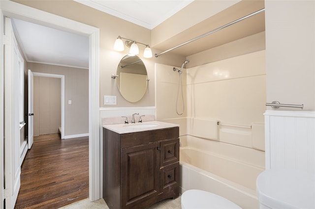 bathroom featuring vanity, bathtub / shower combination, ornamental molding, and toilet