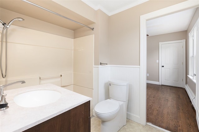 bathroom with crown molding, toilet, a shower, and wainscoting