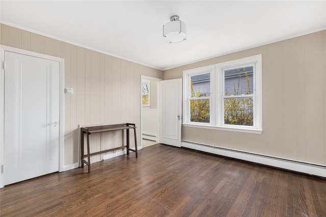 unfurnished room featuring ornamental molding, a baseboard radiator, and dark wood-style floors