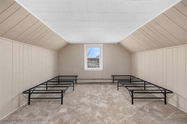 bonus room with wooden walls, carpet floors, lofted ceiling, and baseboard heating