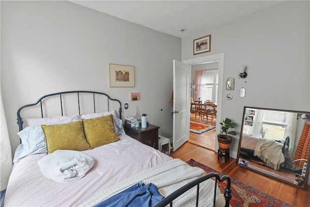 bedroom with baseboards and wood finished floors