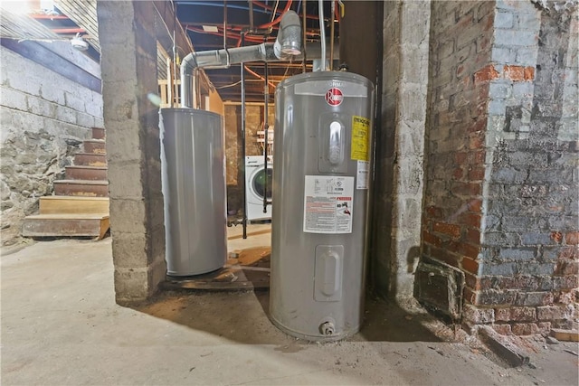 utility room featuring electric water heater, water heater, and washer / dryer